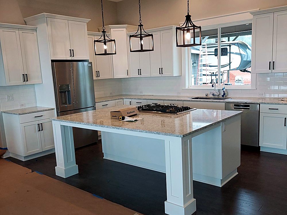 Remodeled kitchen with a new island and stone countertops